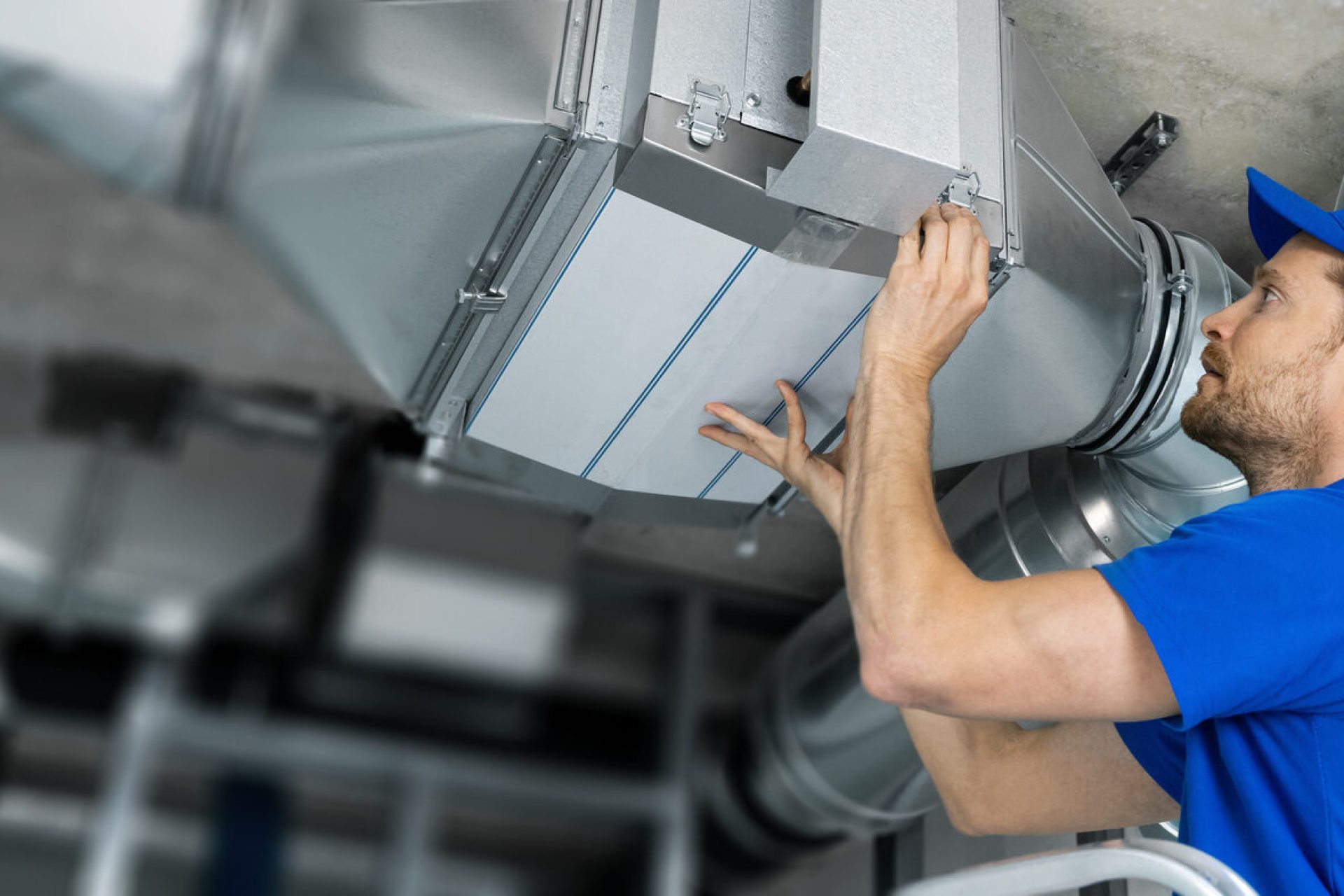 A heating and cooling expert performs commercial HVAC maintenance