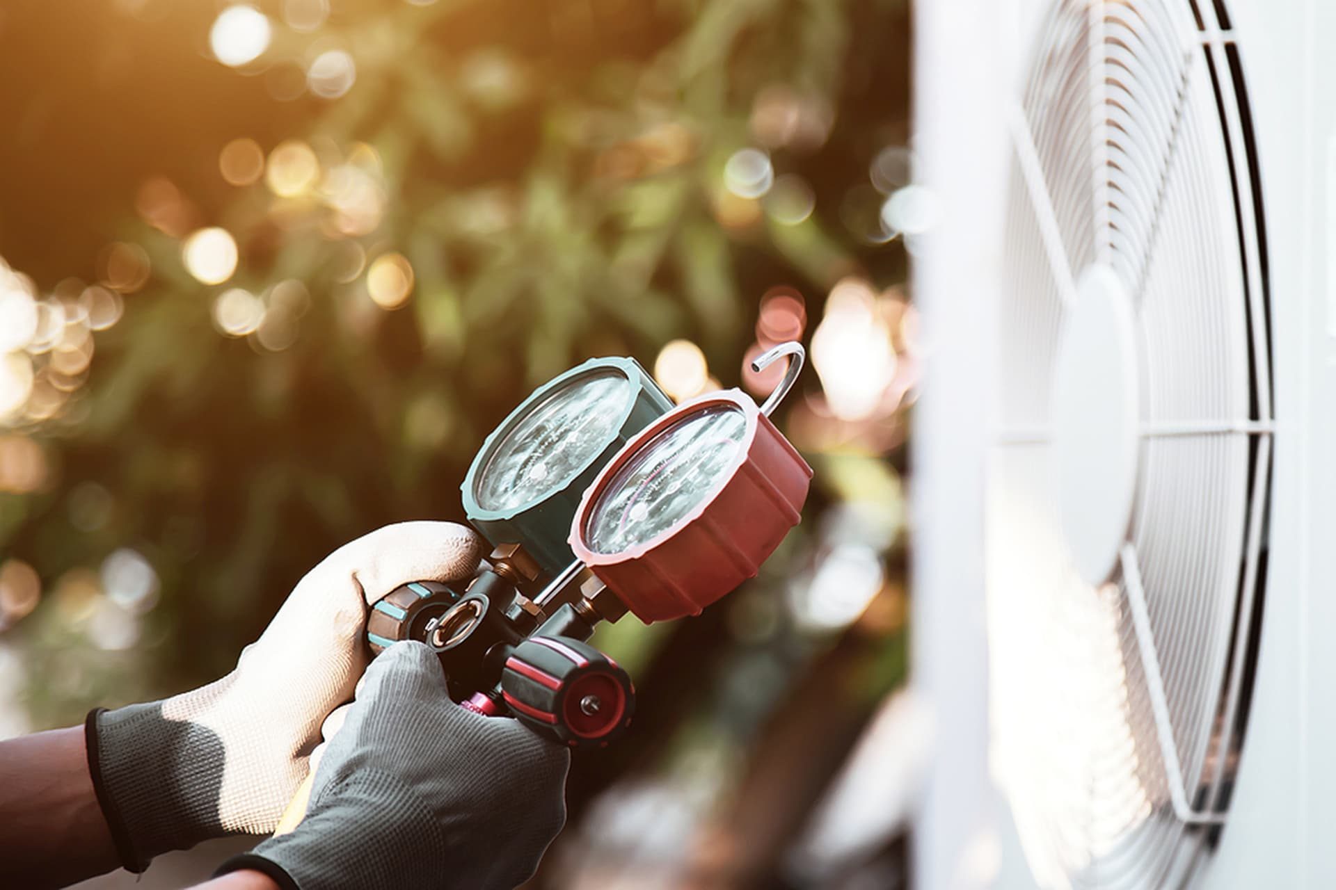 An HVAC technician performs an inspection on a heat pump
